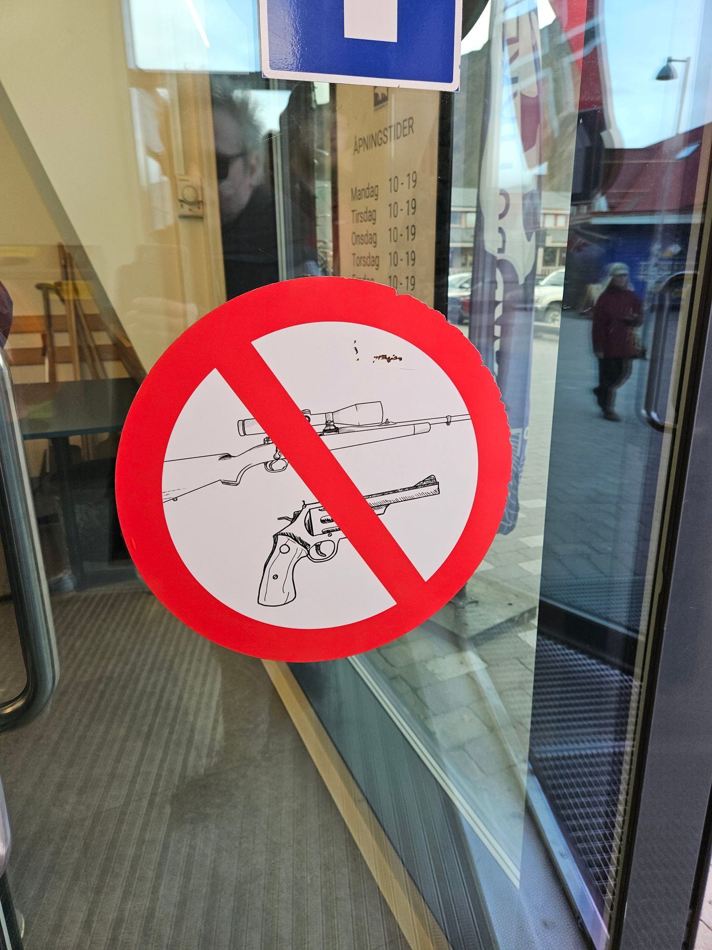 No firearms past this door, on the glass of the Coop