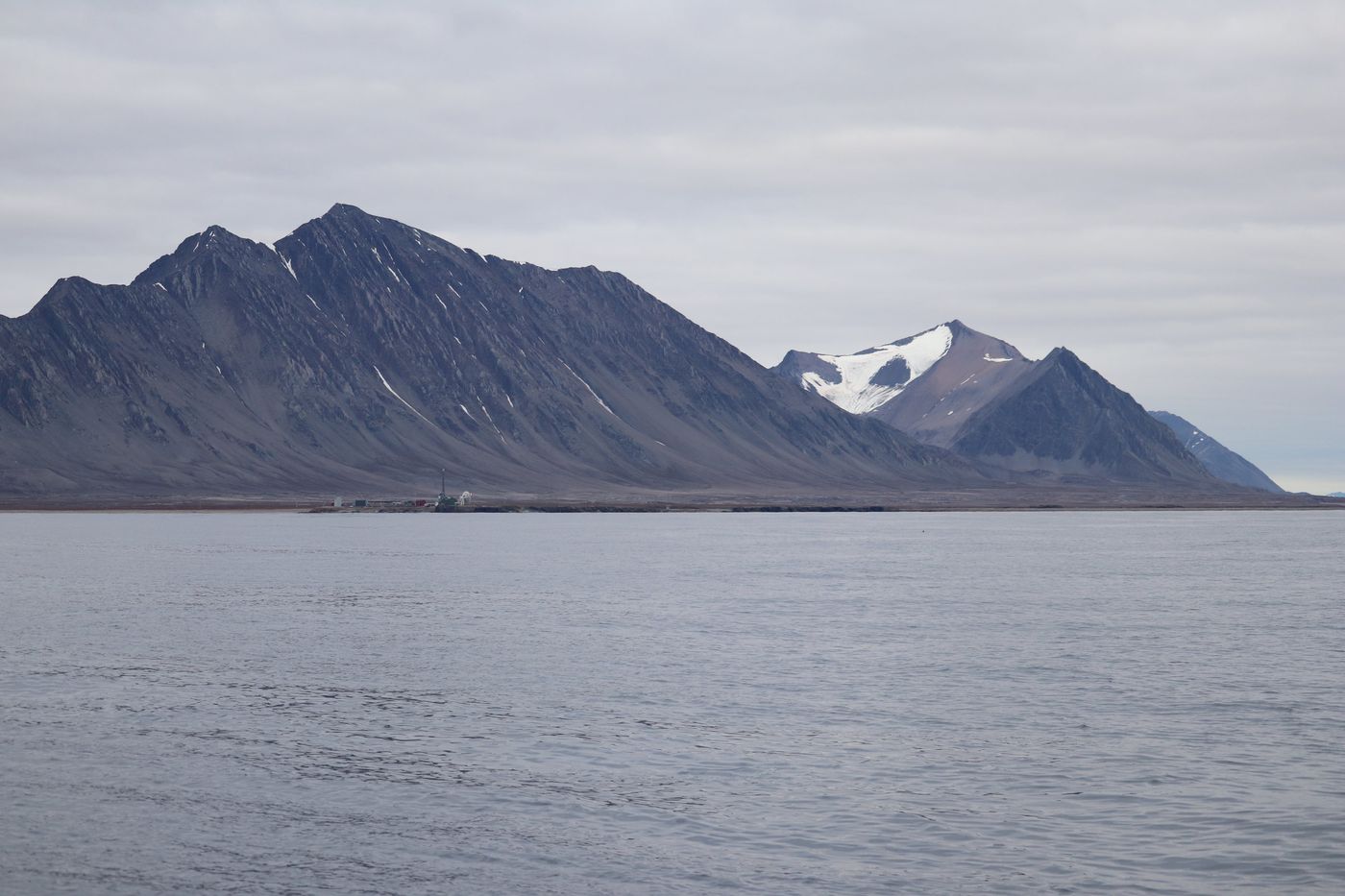Snow peaks and glacier across the fjord from town