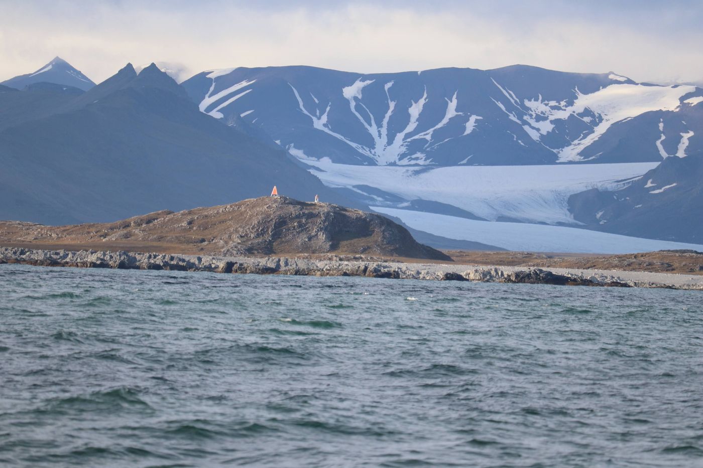 A beacon on the headland, glacier stacked behind