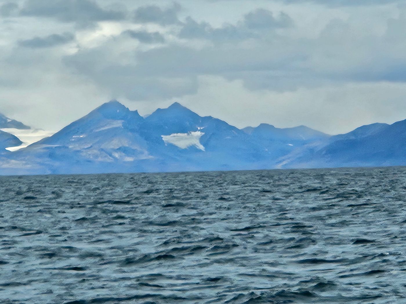 Serrated blue peaks stand over a cold sea