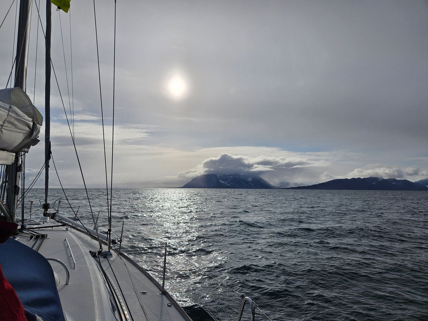 Midnight sun lays a silver road across the water