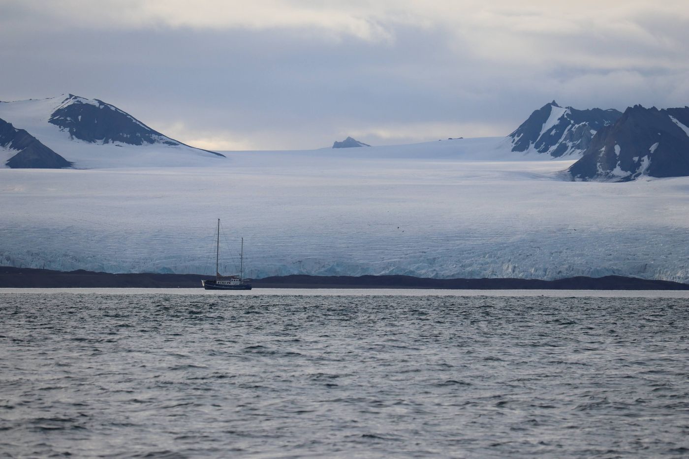 Fog drowns the glacier and leaves only the peaks