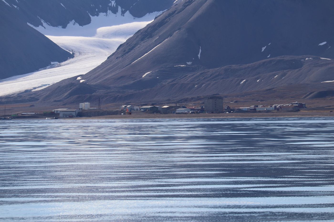 Ny-Ålesund, thirty-five people, seen across the fjord
