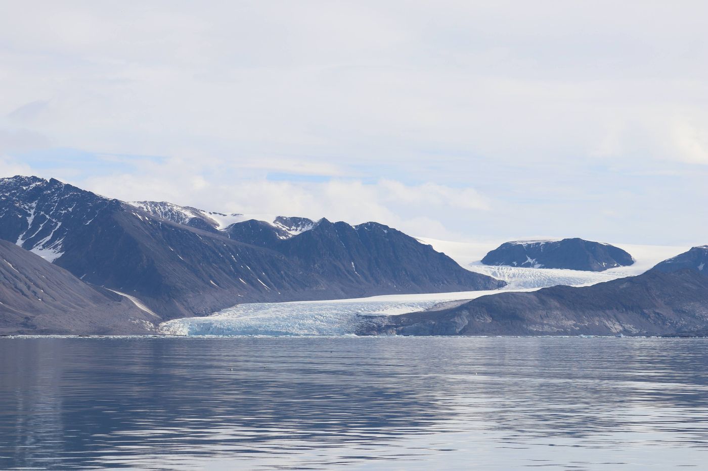 Glacier front and its reflection at the fjord head