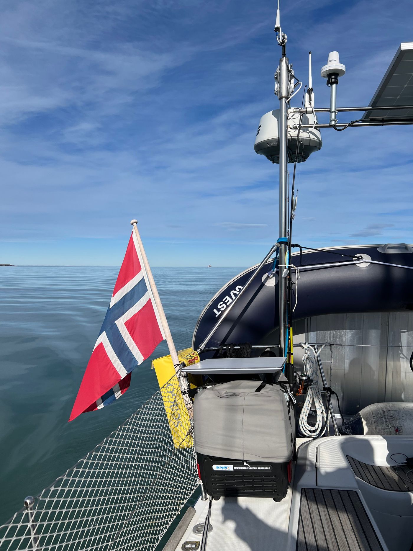The ensign hanging dead still off the stern