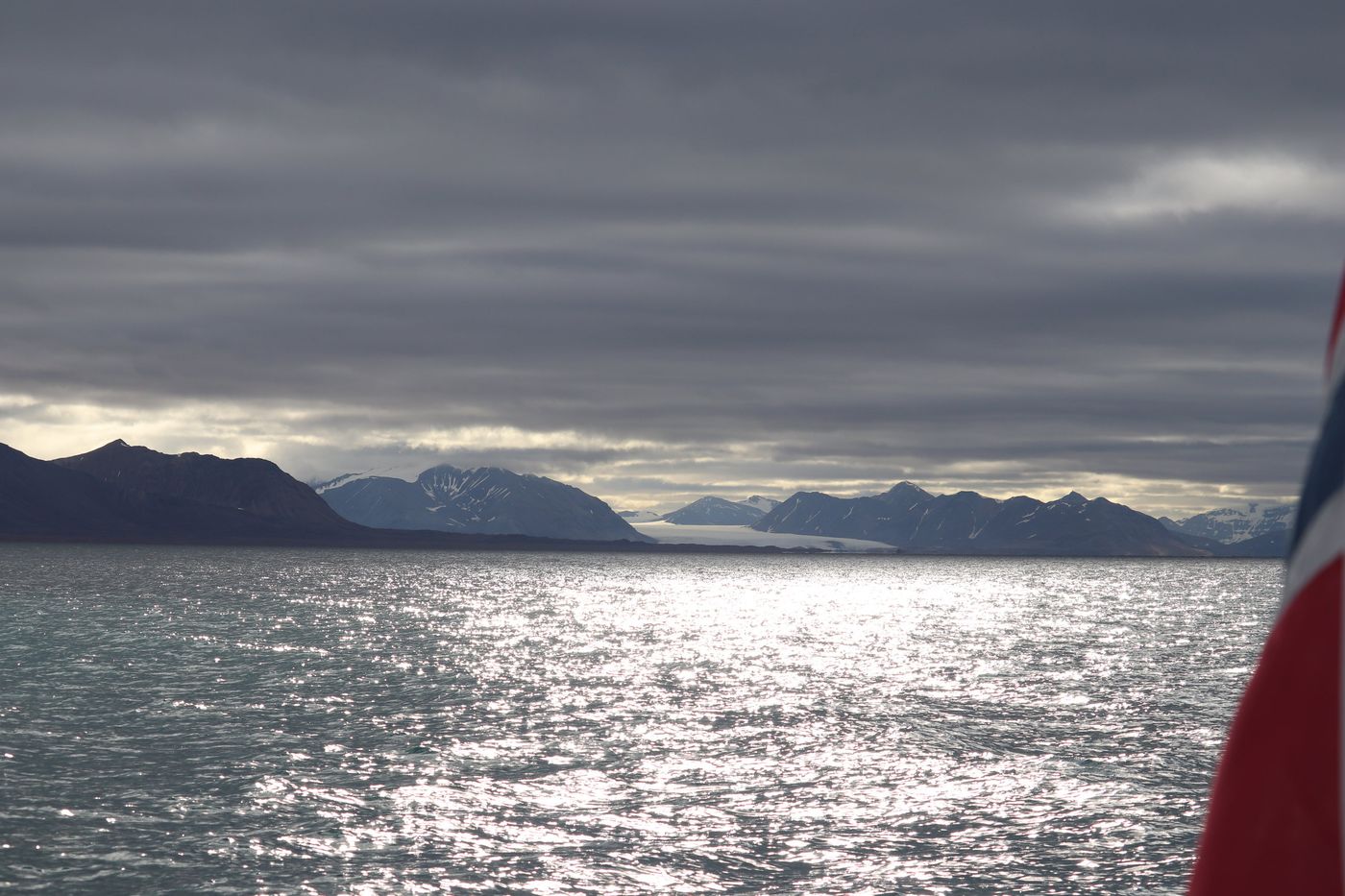 Silvered water and the ensign as we run for the sea
