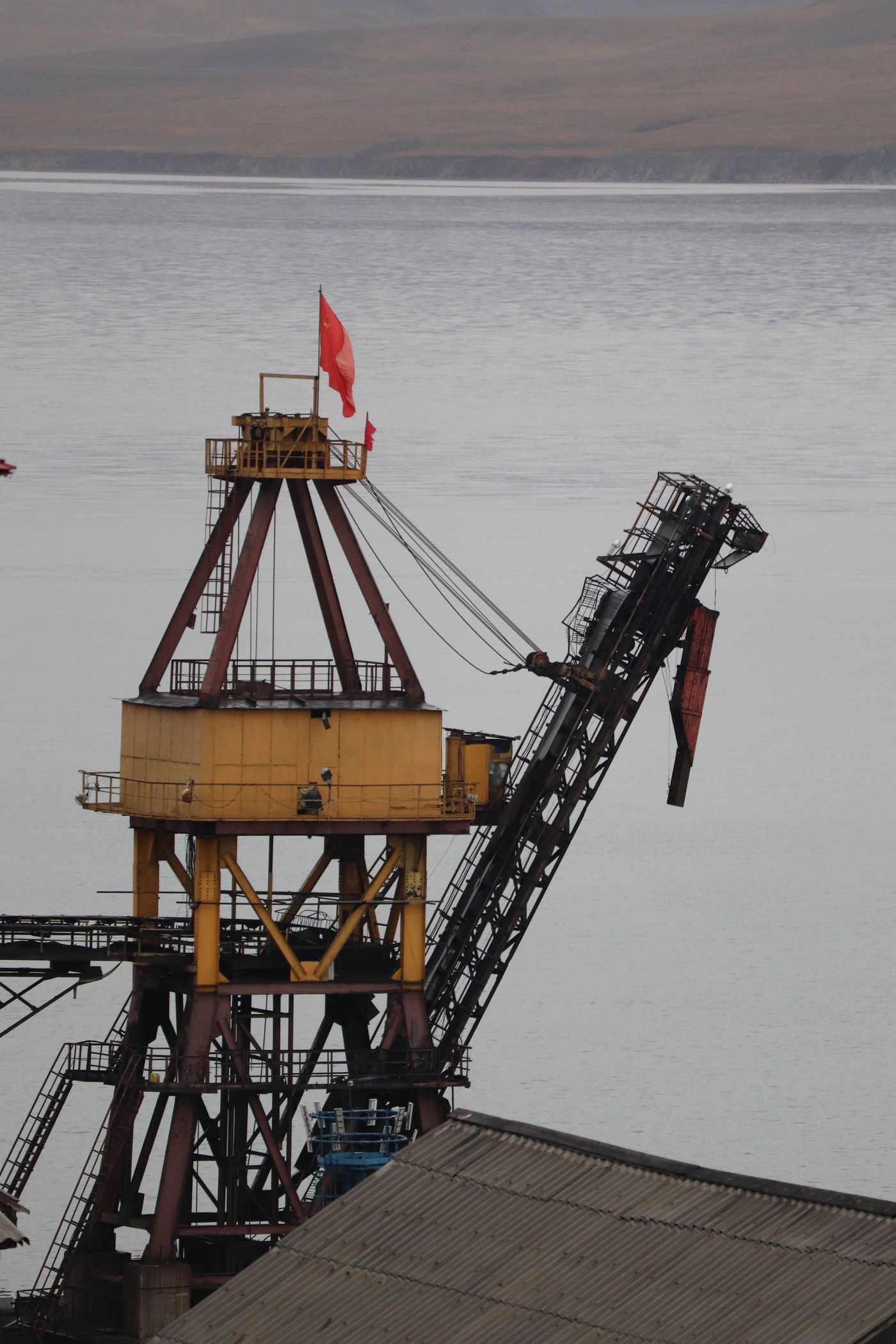 Coal-loading derrick and red flag over Gronfjorden