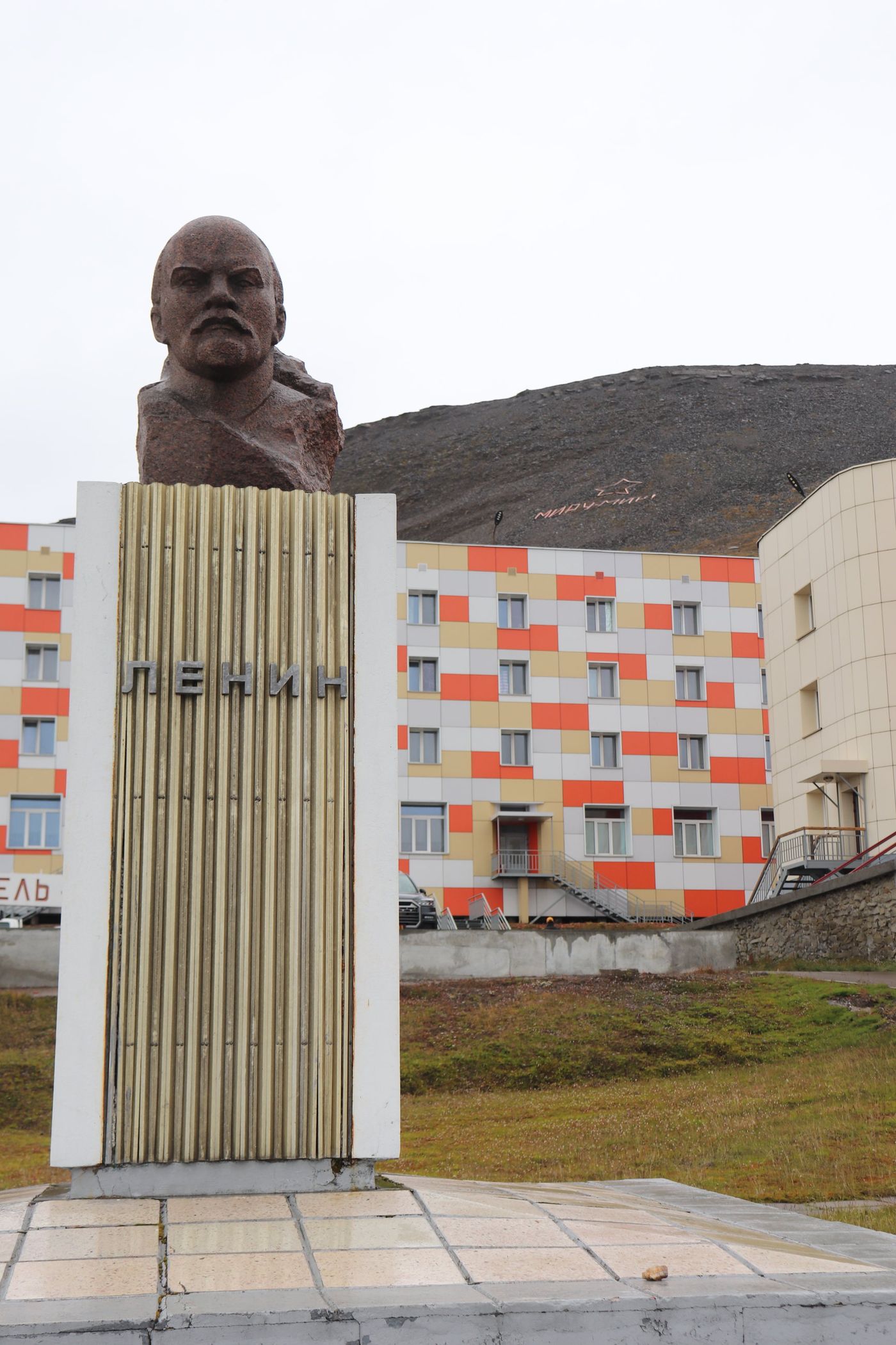 The Lenin bust facing the painted apartment blocks