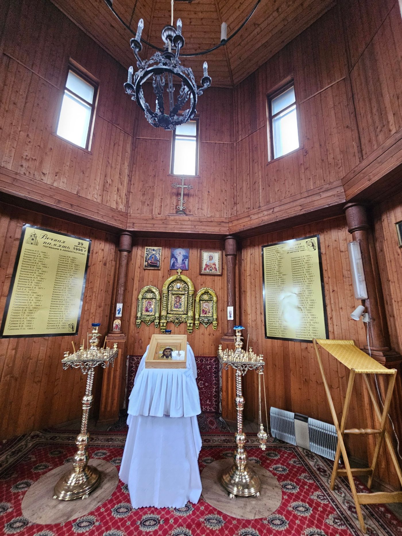 Icons and candles in the wooden Orthodox chapel