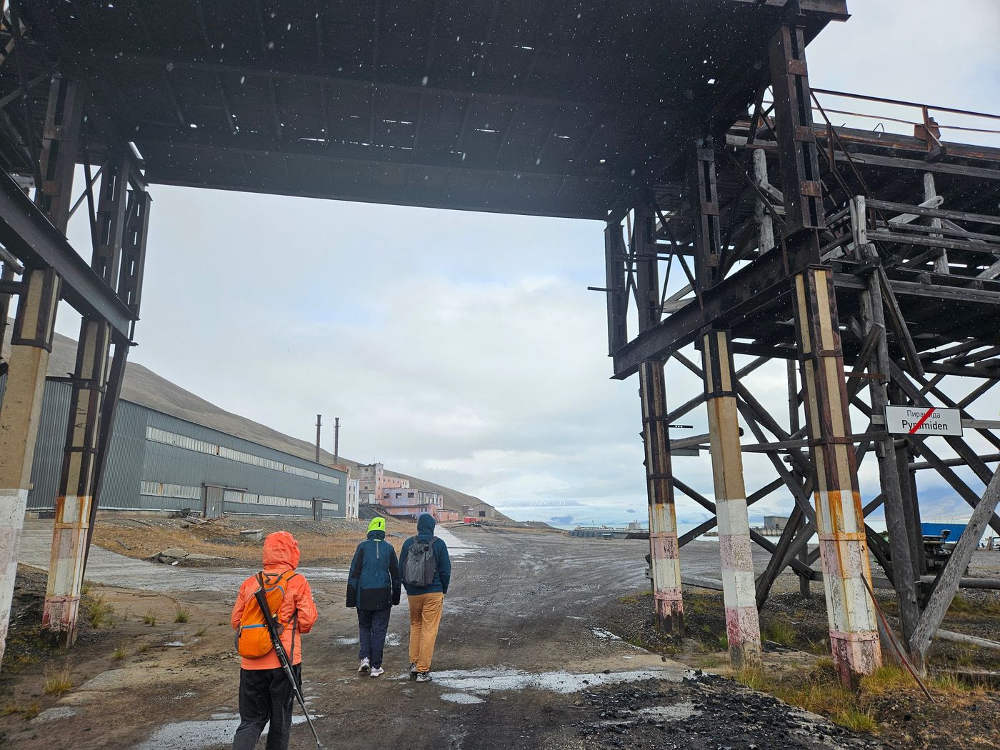 Under the coal gantry, three walkers for scale