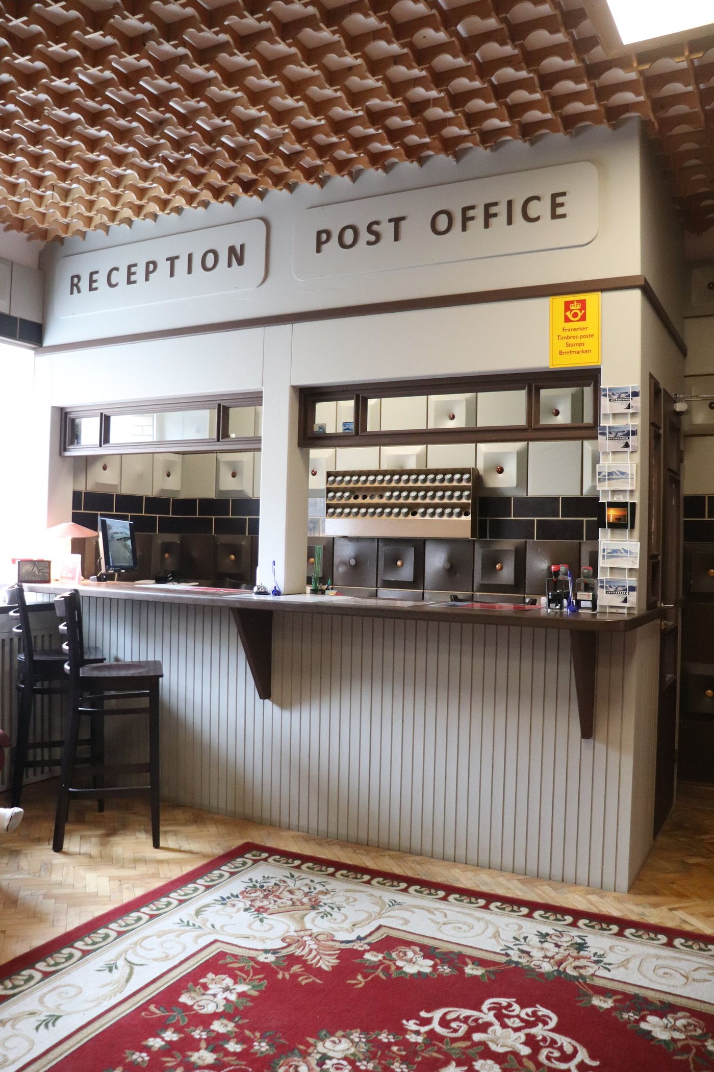 Reception and post office, the only lit counter in town