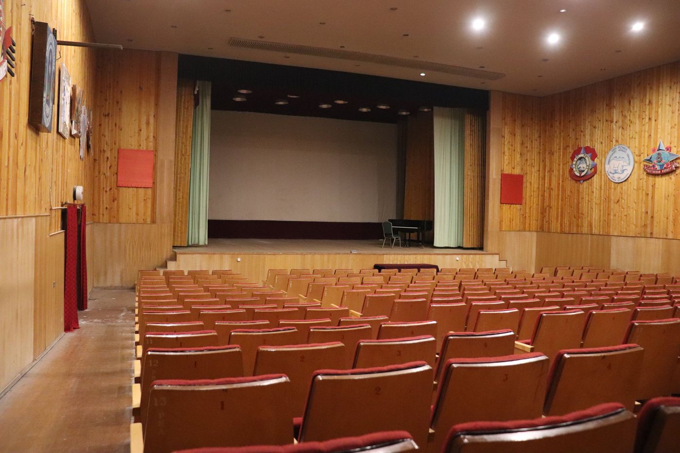Rows of seats still facing the stage in the theatre