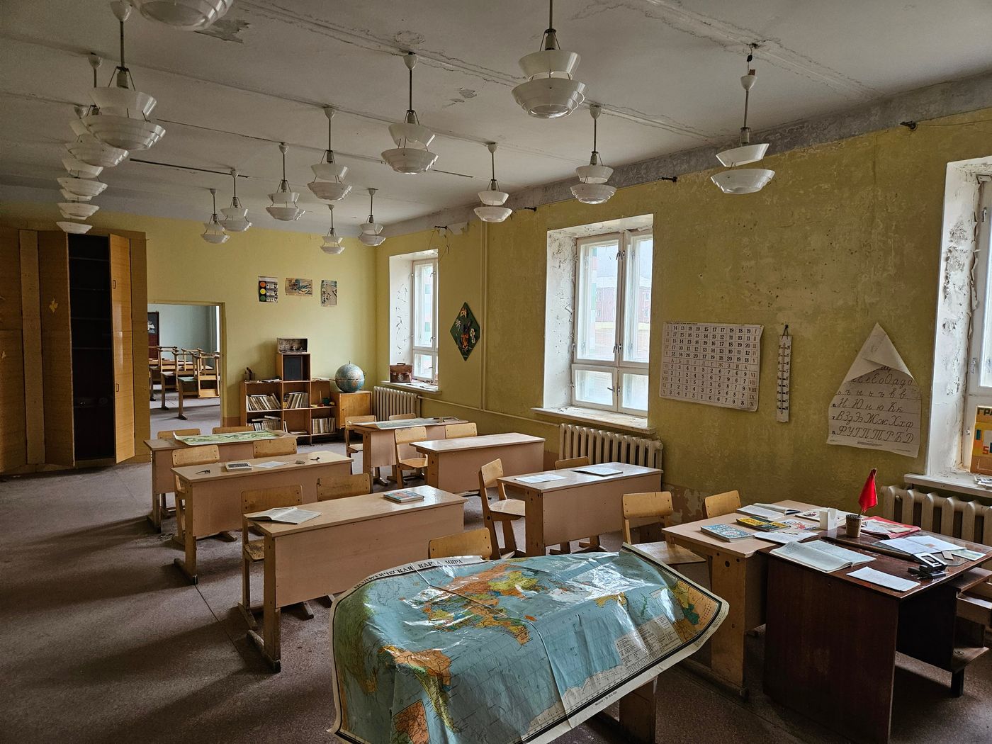School desks still set out under the chandeliers