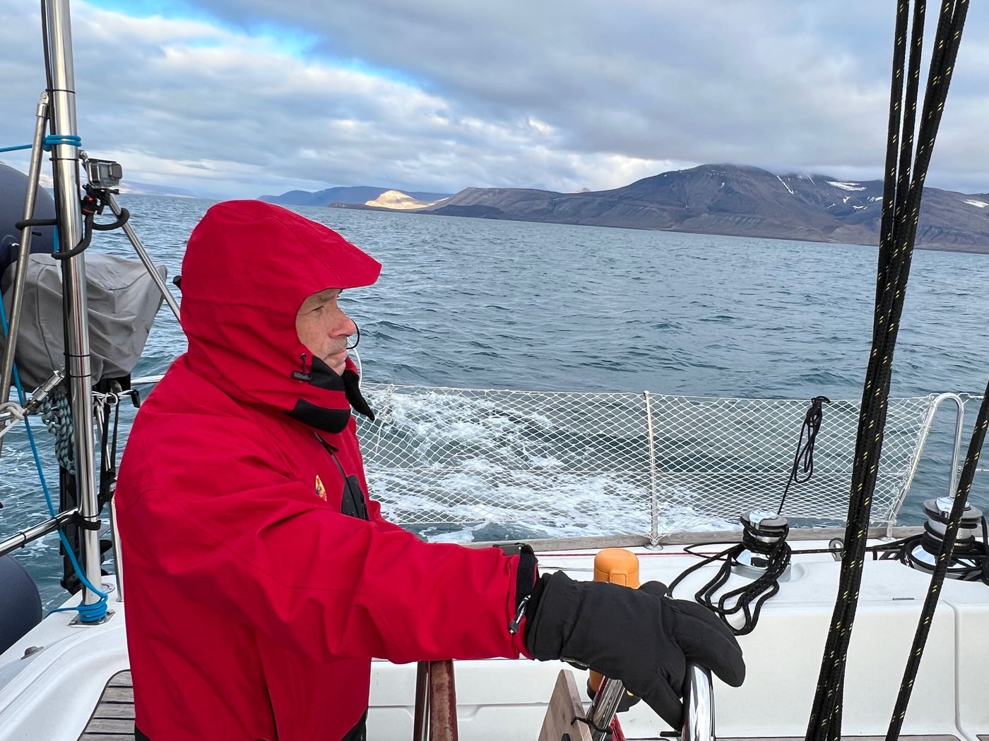 Hand steering in the cold, wake curling astern