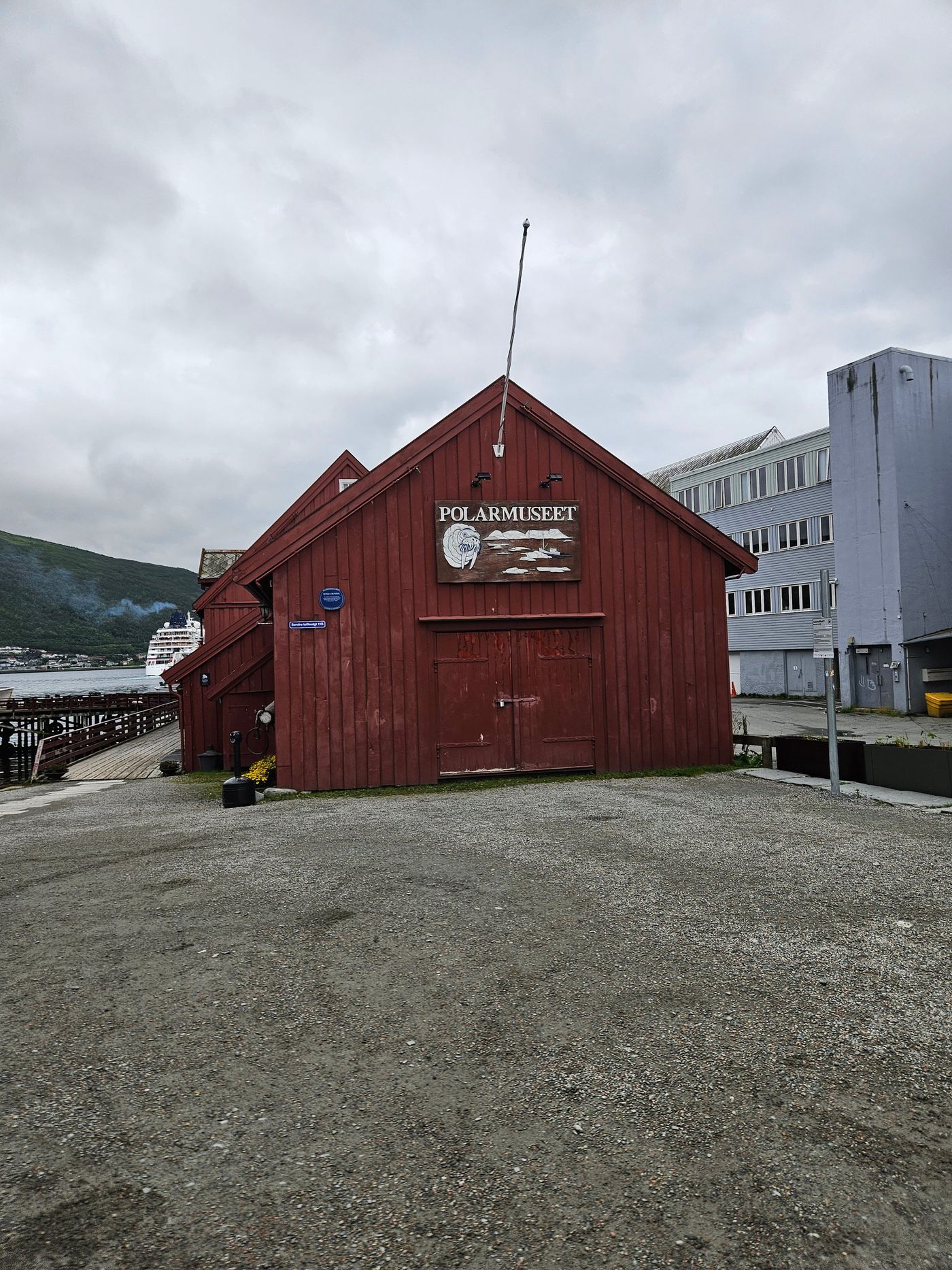 Red timber warehouse standing on the Tromso quay